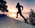 Regular run at lake. Man runner sprinting outdoor in scenic nature