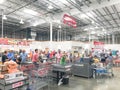 Regular and self-checkout kiosks area with busy customers of Costco in Dallas