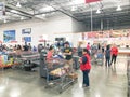 Regular and self-checkout kiosks area with busy customers of Costco in Dallas