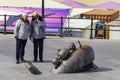 Regular Senior couple walk and looking at a sculpture