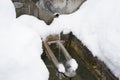 Regulated natural spring or source of water arranged into a fountain in winter captured in high angle view. Royalty Free Stock Photo