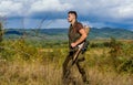 Regulation of hunting. Hunter rifle gun stand top of mountain. Guy bearded hunter spend leisure hunting on birds Royalty Free Stock Photo