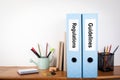 Regulations and Guidelines binders in the office. Stationery on a wooden shelf Royalty Free Stock Photo