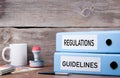 Regulations and Guidelines. Two binders on desk in the office. B Royalty Free Stock Photo