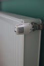 Regulator of heating system radiator in the bedroom Royalty Free Stock Photo