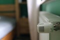 Regulator of heating system radiator in the bedroom Royalty Free Stock Photo