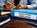 Regulatory compliance papers in the folder and manager. Royalty Free Stock Photo