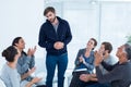 Rehab group applauding delighted man standing up