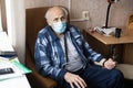 Rehabilitation after coronavirus infection. Elderly man in face medical mask in hospital room during covid-19 pandemic