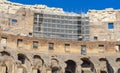 Rehabilitation works inside the Colosseum in Rome with scaffolding above the vaulted arches, Italy.