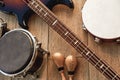 At the rehearsal in the studio. Top view of musical instruments set: brown electric guitar, drums, gold maracas and