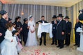 Rehovot, Israel - 11.01.2019. Jewish groom puts on tallit surrounded by relatives, bride and rabbi