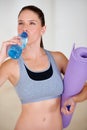 Rehydrating. An attractive young woman drinking a bottle of water.