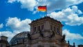 The Reichstag building with a waving flag of the Federal Republic of Germany