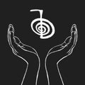 Reiki symbol. A sacred sign CHO KU REI. A hand holds Reiki CHO KU REI sign on a black background