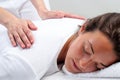 Reiki therapist doing treatment on woman.