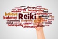 Reiki word cloud and hand with marker concept Royalty Free Stock Photo