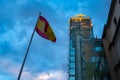 Reina Sofia Museum, High Building with Transparent Windows and a Spanish Flag next to it, at Sunset