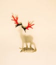 Reindeer Christmas ornament casting shadow on a yellow pastel background with red antlers. Royalty Free Stock Photo