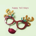 Reindeer eyeglasses and text happy holidays