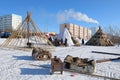 Reindeer herders install dwellings in winter near modern city buildings