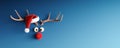 Reindeer with red nose and Santa hat on blue Christmas background Royalty Free Stock Photo