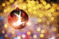 Reindeer reflection on red ball on yellow abstract bokeh blurred background Royalty Free Stock Photo