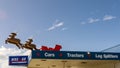 Reindeer and sleigh sculpture perched atop Hire and GO, Winton, against a bright blue sky, South Island, New Zealand.