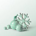 Reindeer standing on Christmas balls, and snow star on soft mint  background Royalty Free Stock Photo