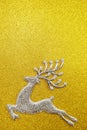 Reindeer and white berry Christmas decoration on yellow glitter background