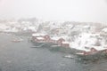 Reine fishing village on Lofoten islands with red rorbu houses in winter with snow. Lofoten islands, Norway, Europe