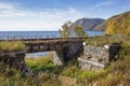 Reinforced concrete bridge on stone abutments across the Dark-1 stream on the shore of Baikal lake Royalty Free Stock Photo