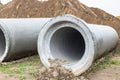 Reinforced concrete storm sewer pipes of large diameter stacked at a construction site. Sewer Large diameter pipes. Wastewater Royalty Free Stock Photo