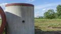 Reinforced concrete storm sewer pipes of large diameter stacked at a construction site. Sewer Large diameter pipes Royalty Free Stock Photo