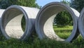 Reinforced concrete storm sewer pipes of large diameter stacked at a construction site. Sewer Large diameter pipes Royalty Free Stock Photo