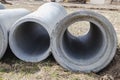 Reinforced concrete storm sewer pipes of large diameter stacked at a construction site. Sewer Large diameter pipes. Wastewater Royalty Free Stock Photo