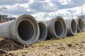 Reinforced concrete storm sewer pipes of large diameter stacked at a construction site. Sewer Large diameter pipes. Wastewater Royalty Free Stock Photo