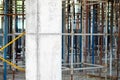 Reinforced concrete structural column against the background of scaffolding for pouring concrete floors at a Royalty Free Stock Photo