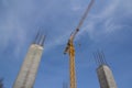 Reinforcement concrete column under construction at the construction site and tower crane against blue sky Royalty Free Stock Photo