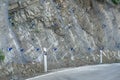 Landslide and rock sliding prevention in Georgia, reinforcing mountain slope with metal mesh. Royalty Free Stock Photo