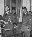 Reinhard Heydrich left with Karl Hermann Frank. Heydrich gives a speech to audience
