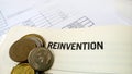 Reinvention word on the book with balance sheet Royalty Free Stock Photo
