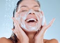 Reinvigorate, renew and restore your senses. Studio shot of a young woman washing her face while taking a shower against Royalty Free Stock Photo