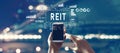 REIT - Real Estate Investment Trust theme with person using smartphone