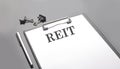 REIT text on the white paper sheet on the black background