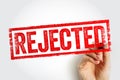 REJECTED stamp held by a hand, delivering a bold textured rejection mark used for declined submissions, failed applications, and Royalty Free Stock Photo