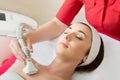 Rejuvenating facial treatment. Model getting lifting therapy massage in a beauty SPA salon Royalty Free Stock Photo