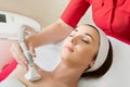 Rejuvenating facial treatment. Model getting lifting therapy massage in a beauty SPA salon