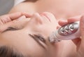 Rejuvenating facial treatment. Model getting lifting therapy massage in a beauty SPA salon Royalty Free Stock Photo