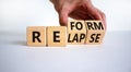 Relapse or reform symbol. Businessman turns cubes and changes the word `relapse` to `reform`. Beautiful white background. Busi